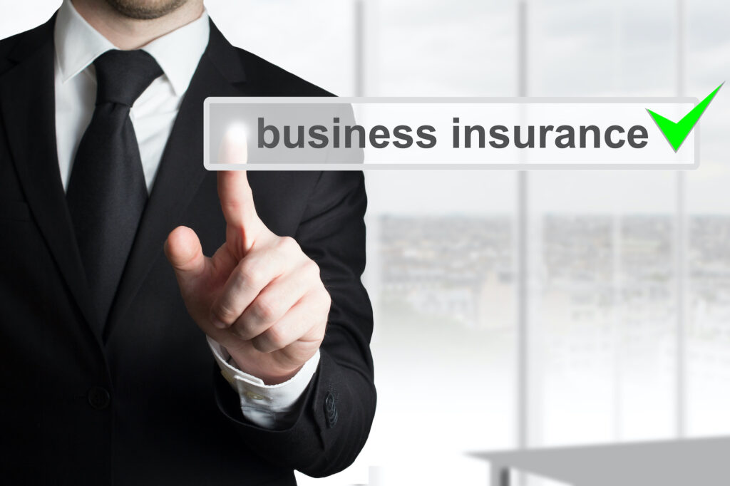 businessman in black suit pushing button business insurance
